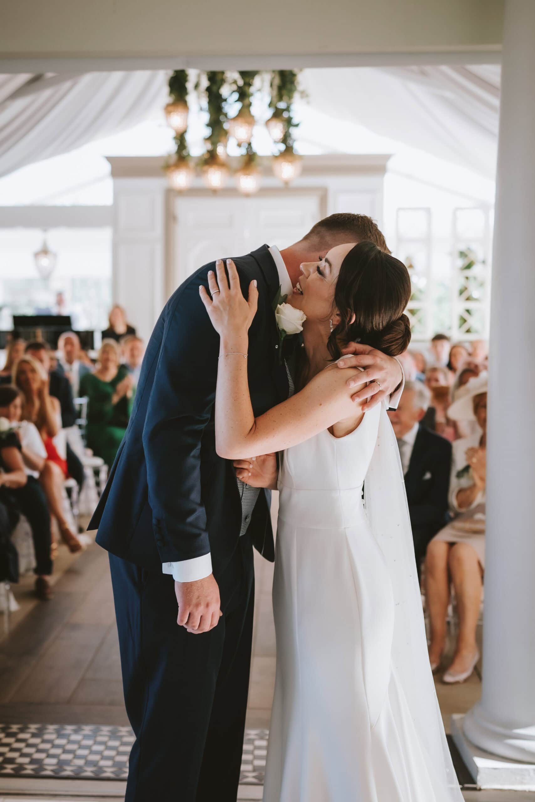 Editorial wedding photography in Essex; a bride and groom sharing an emotional embrace during their ceremony.