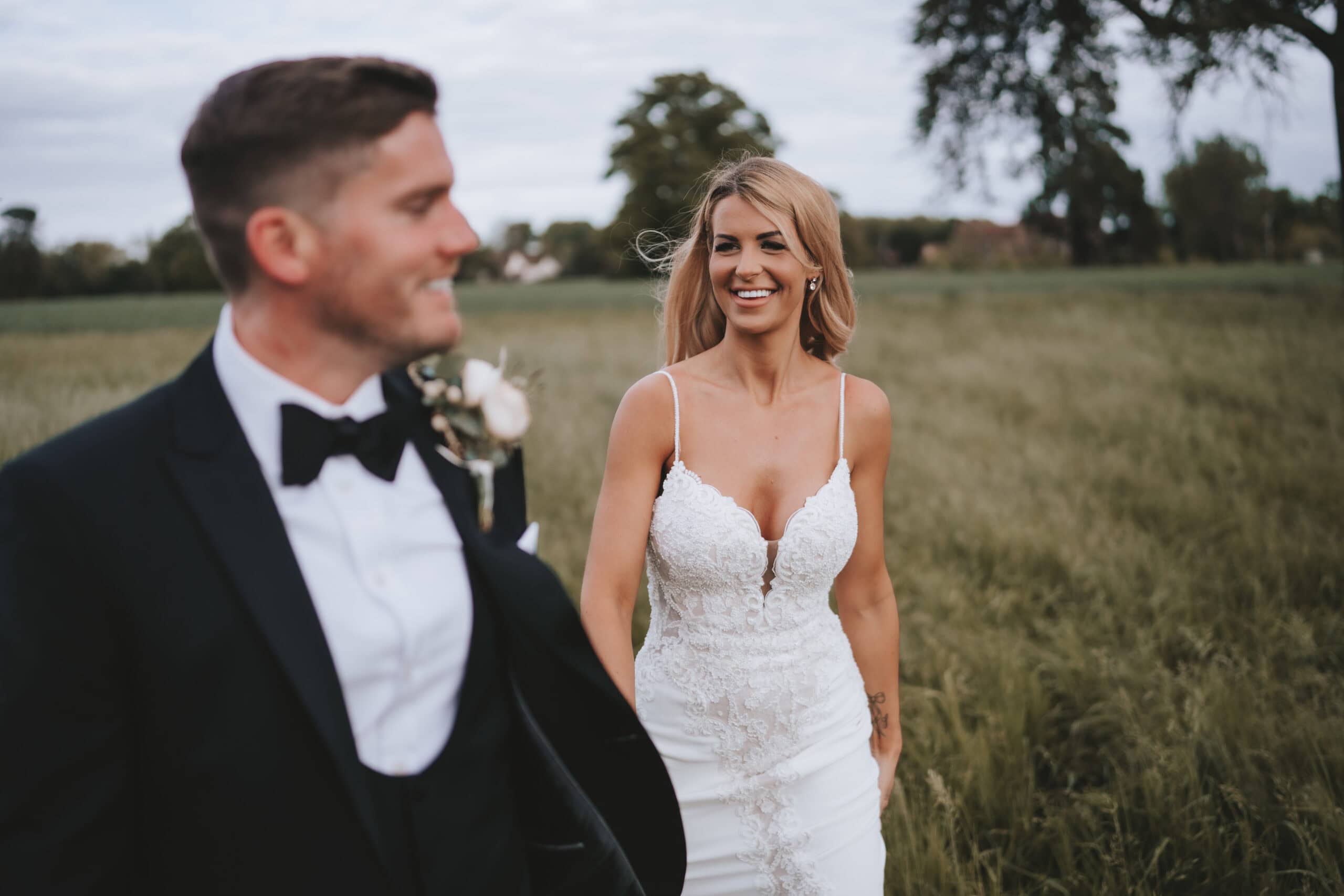 Rosie and Dave in the grounds at Gosfield Hall, Essex, on their spring wedding day – 12th May 2022, photographed by Tel, Lily & White