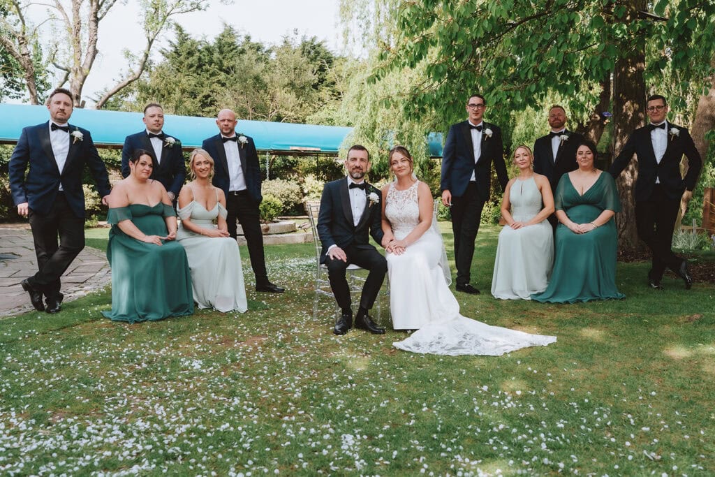 Wedding party group photo on the lawn at Friern Manor in Brentwood – photographed by Lily & White