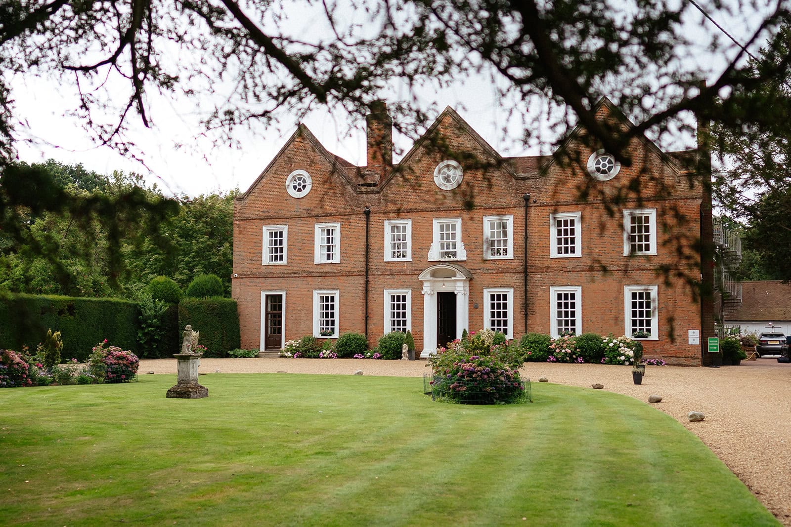 Georgian redbrick facade of Hutton Hall wedding venue with formal gardens in Brentwood, Essex — photographed by Lily & White