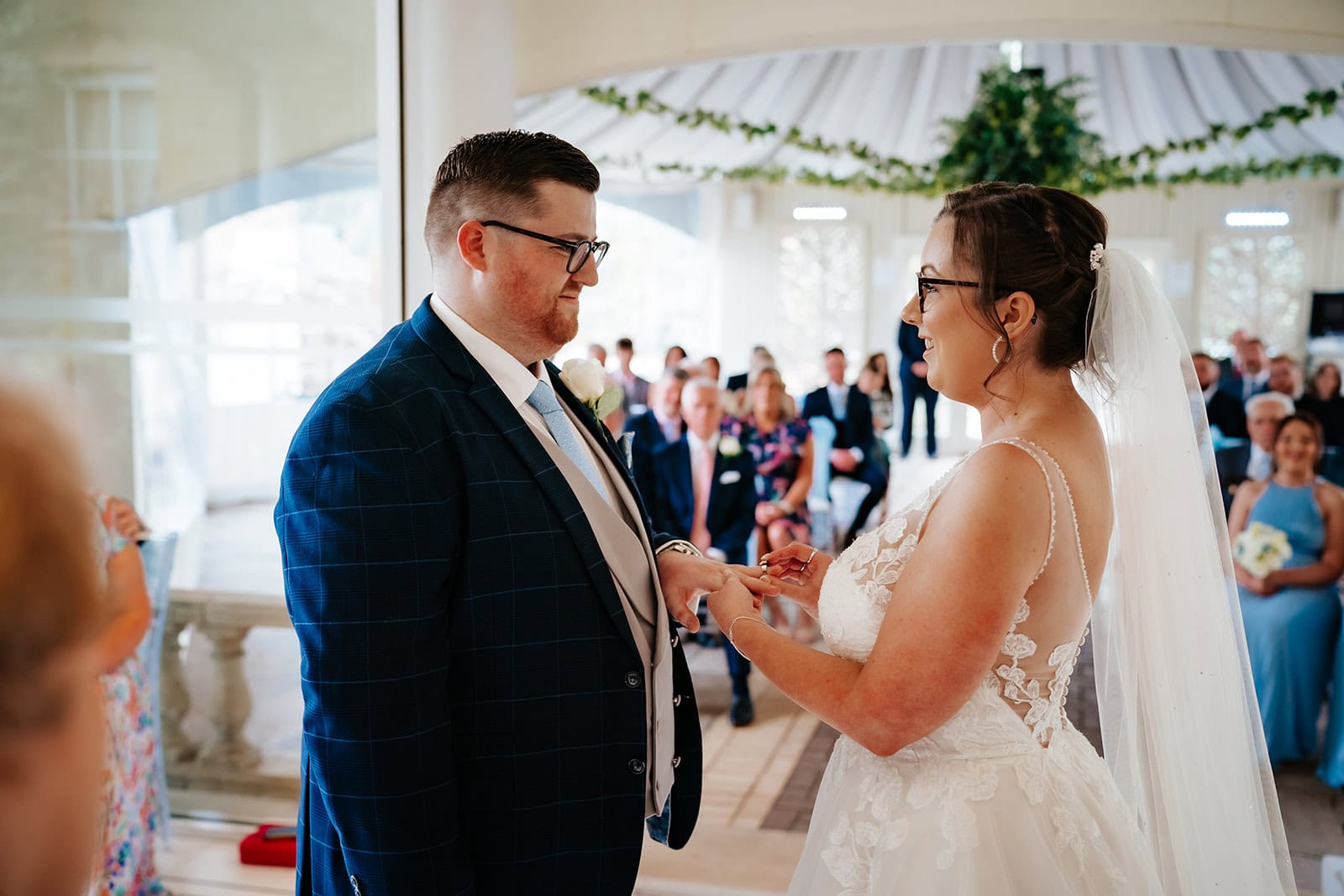 Hollie and Lewis exchanging rings at their spring wedding ceremony at Friern Manor, Brentwood, Essex – 21st April 2023, photographed by Tel, Lily & White